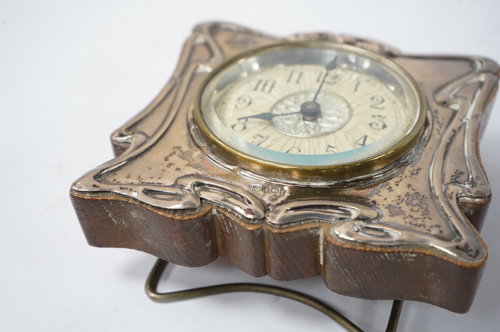 An Edwardian Art Nouveau silver mounted timepiece, Joseph Gloster Ltd, Birmingham, 1904, height 12.7cm. Condition - poor